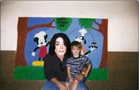 Photoshop Request Threads — A family posed in front of a cartoon theme park backdrop with yet another version of facial editing applied.