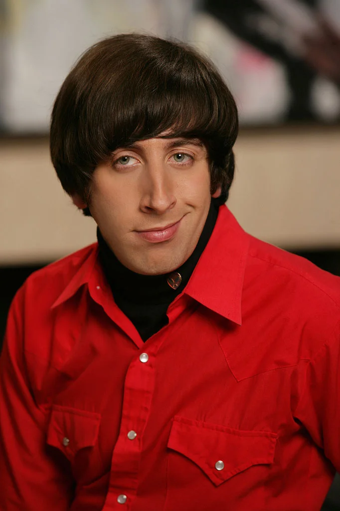 Portrait of Howard Wolowitz in a red shirt smiling slightly, the base image for the Pickup Line Scientist meme