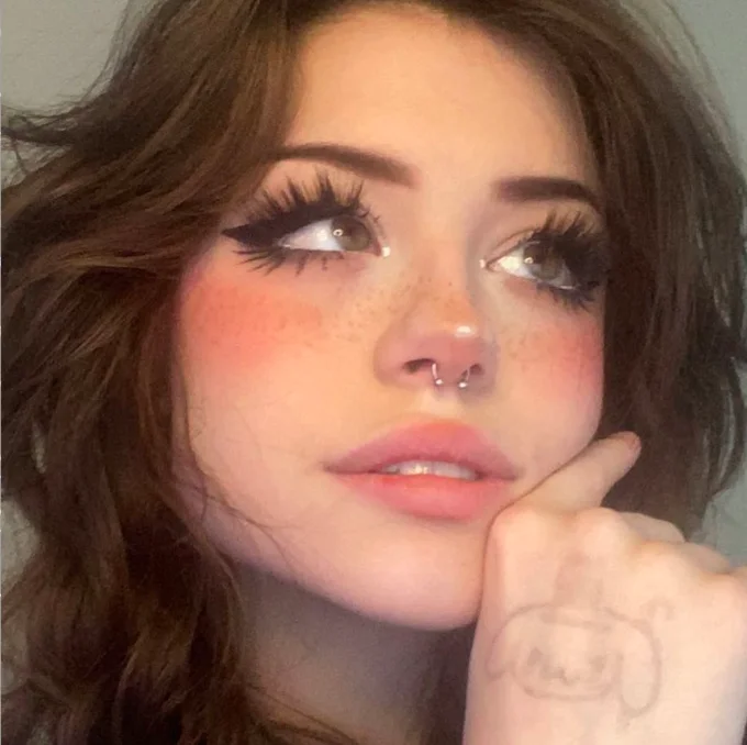 Pink Nose E-Girl Makeup — Selfie of a woman with pink nose blush, freckles, septum piercing and dramatic lashes