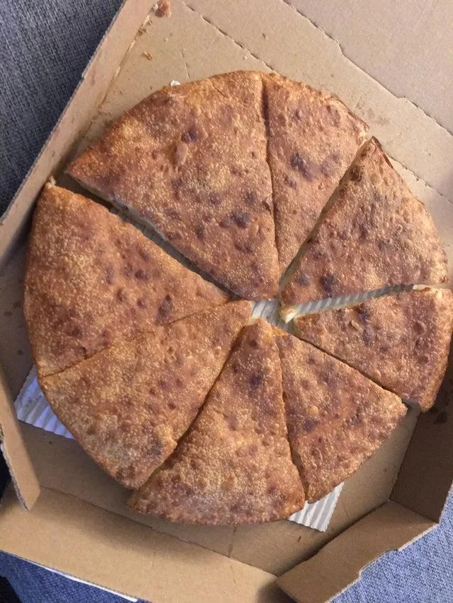 Pizza Crimes — A pizza cut into eight triangular pieces arranged in a radial pinwheel pattern from the center in unconventional geometry.