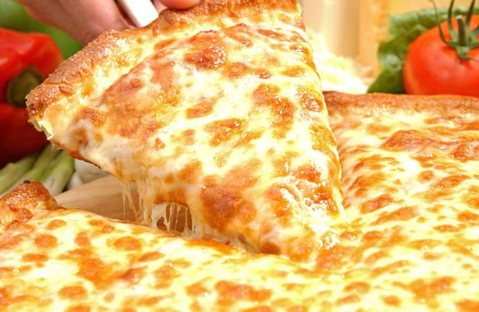 Cheese pizza slice being pulled up with stretching mozzarella cheese