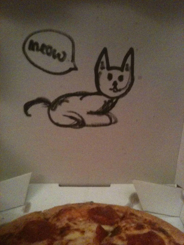 Pizza box lid with hand drawn cat saying meow above a pepperoni pizza