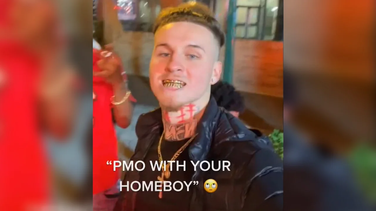 Pmo Slang — Young man with gold grill and neck tattoos with overlaid text reading PMO WITH YOUR HOMEBOY and an eye-roll emoji.