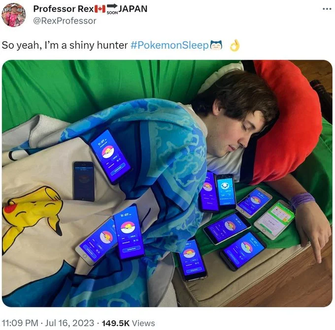 Person sleeping on a bed covered in many phones running Pokémon Sleep