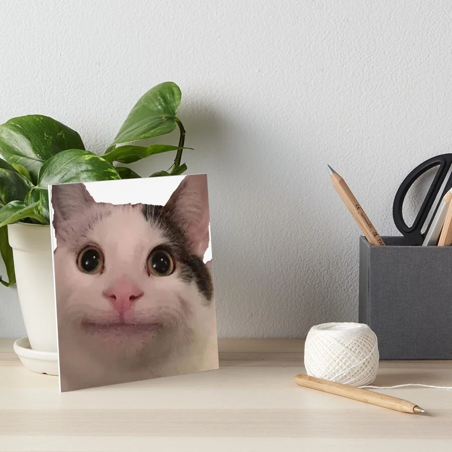 A handmade greeting card featuring a printed image of the polite cat's face in a desk setting with plants and supplies.
