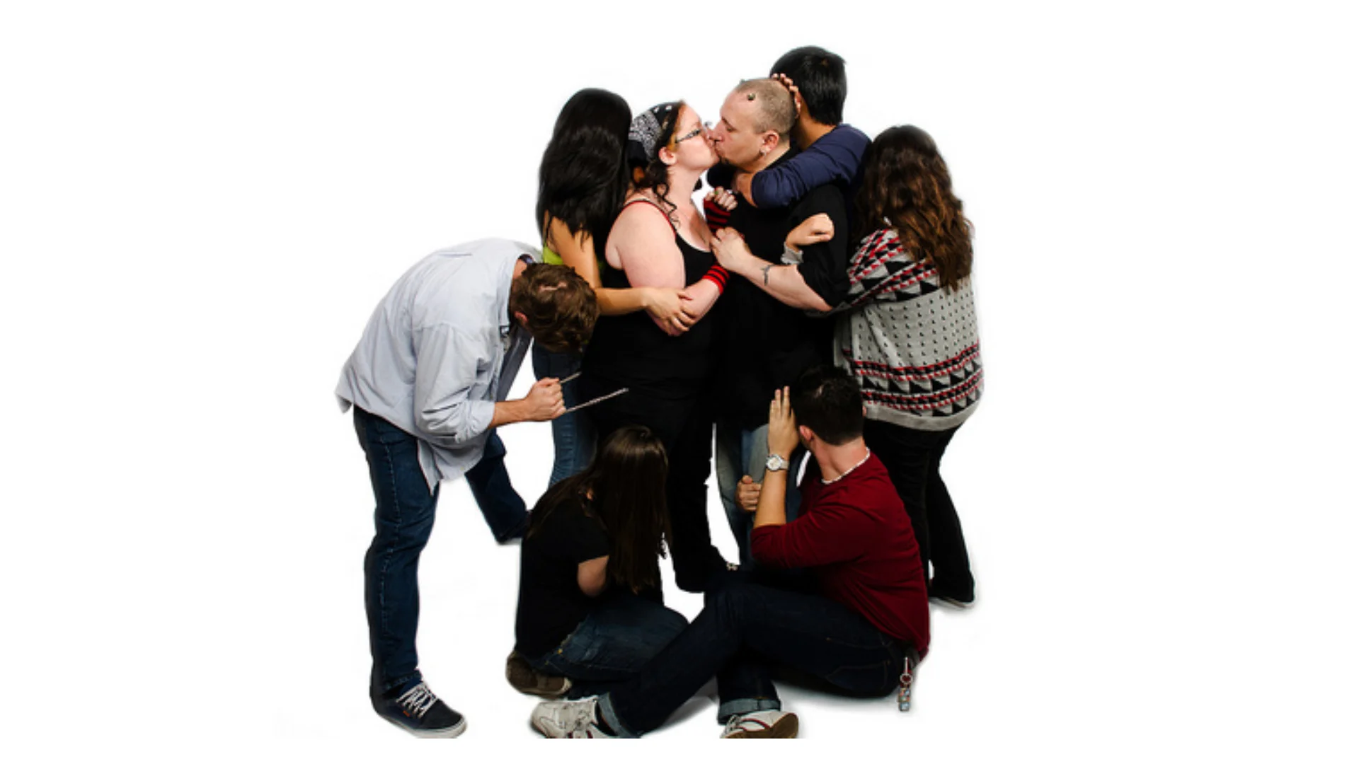 Group of eight people embracing on a white background with a couple kissing in the center, illustrating a polyamorous polycule.