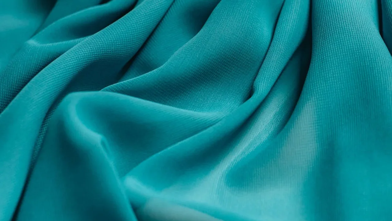 Polyester (Slang) — Close-up of draped teal polyester fabric