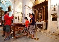 Potato Jesus — A photograph inside the Sanctuary of Mercy showing multiple tourists and rope barriers around the botched fresco area.