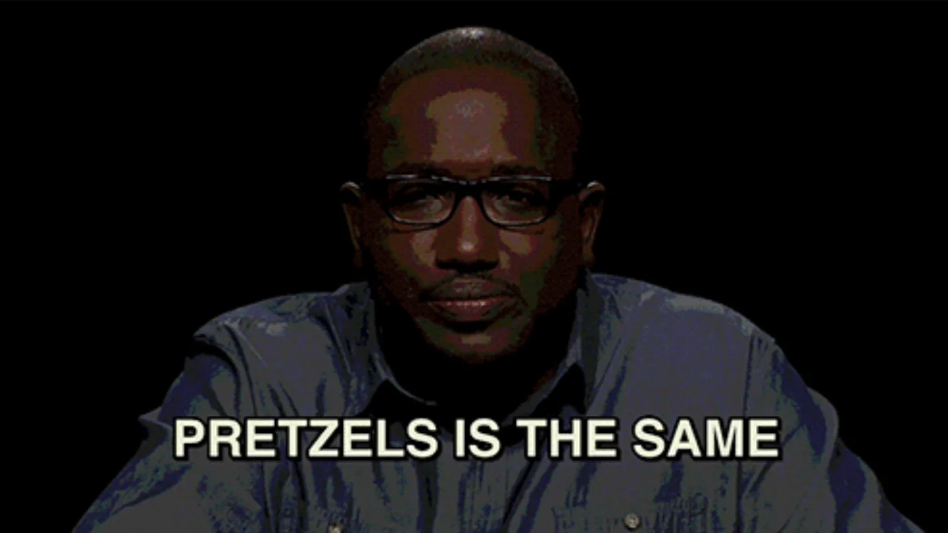 Hannibal Buress with glasses saying 'PRETZELS IS THE SAME' against a black background