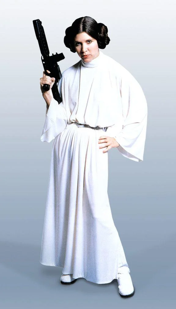 Princess Leia in a white gown holding a blaster, full-body promotional photo.