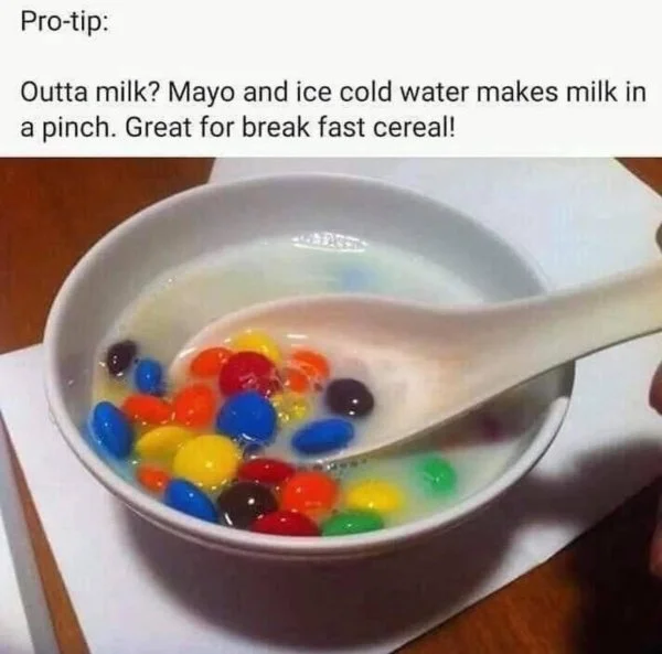 PROTIP — Bowl of M&Ms in white liquid captioned as a fake pro-tip about substituting mayo for milk.