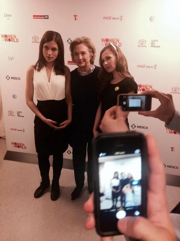 Pussy Riot members Tolokonnikova and Alyokhina posing with Hillary Clinton at Women in the World event.
