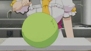 Quality — An anime character dressed in a maid outfit with a yellow tie working with an oversized, perfectly spherical green object on a kitchen counter with