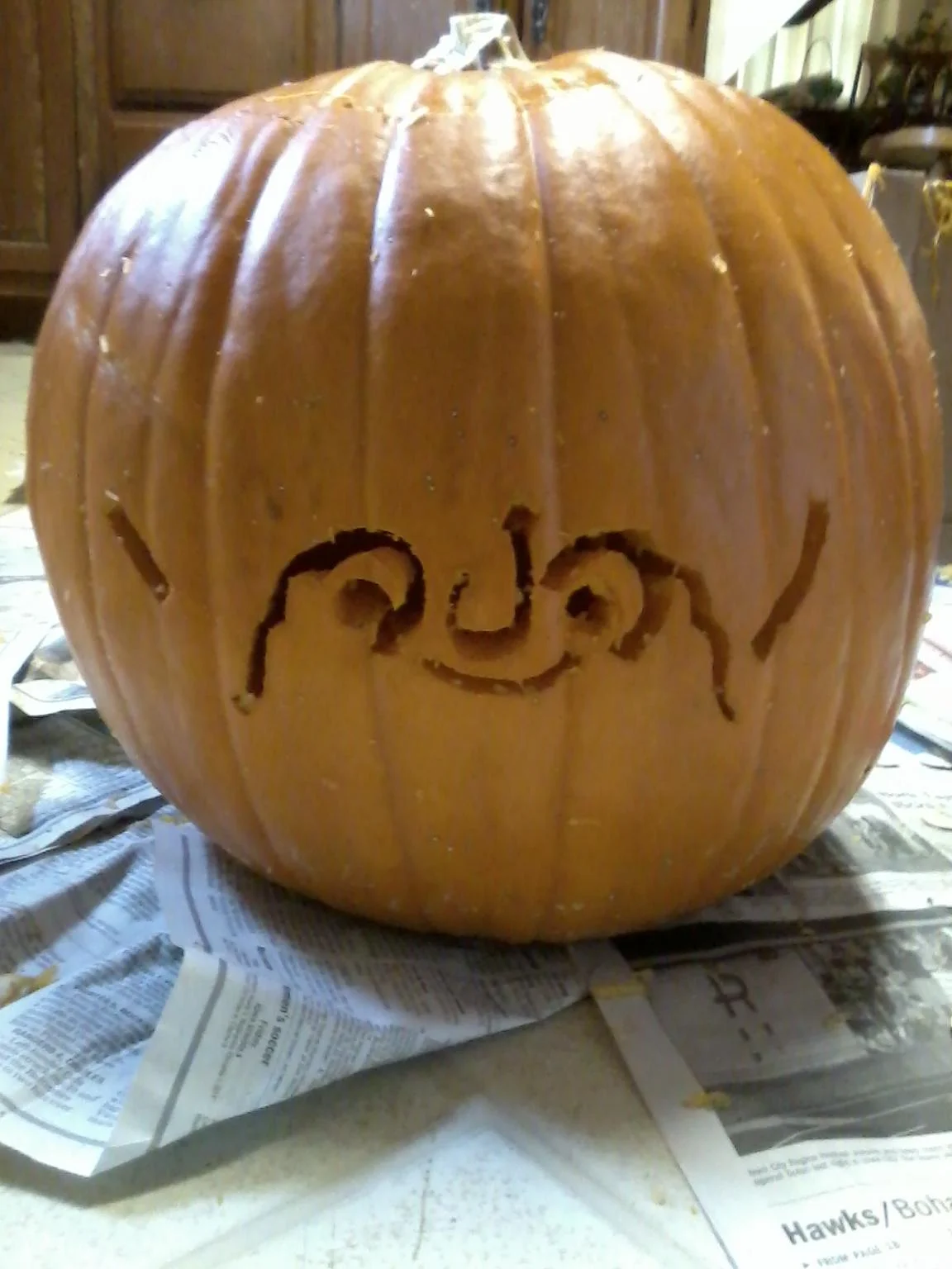 Halloween pumpkin carved with the raise your dongers kaomoji face