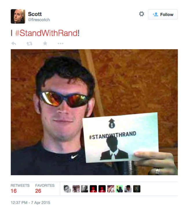 Rand Paul — Twitter user holding a StandWithRand supporter sign