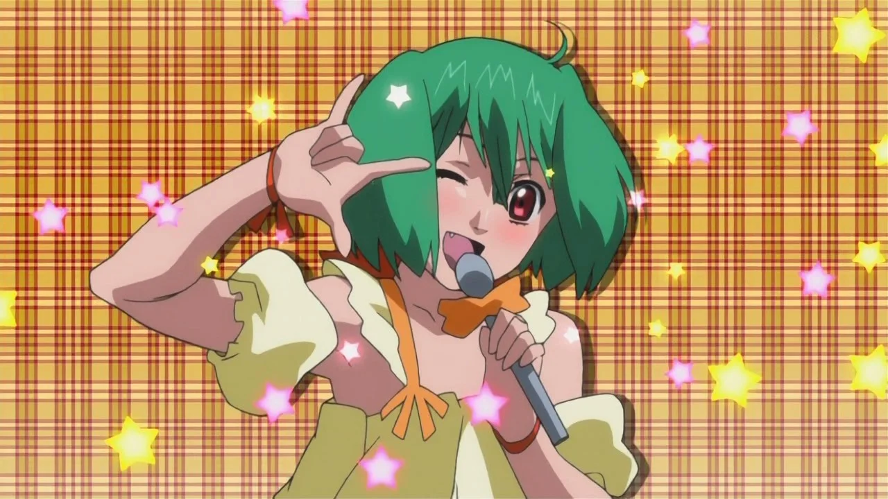Ranka Lee's Kira Pose — Anime screenshot of Ranka Lee winking and doing the kira pose with microphone