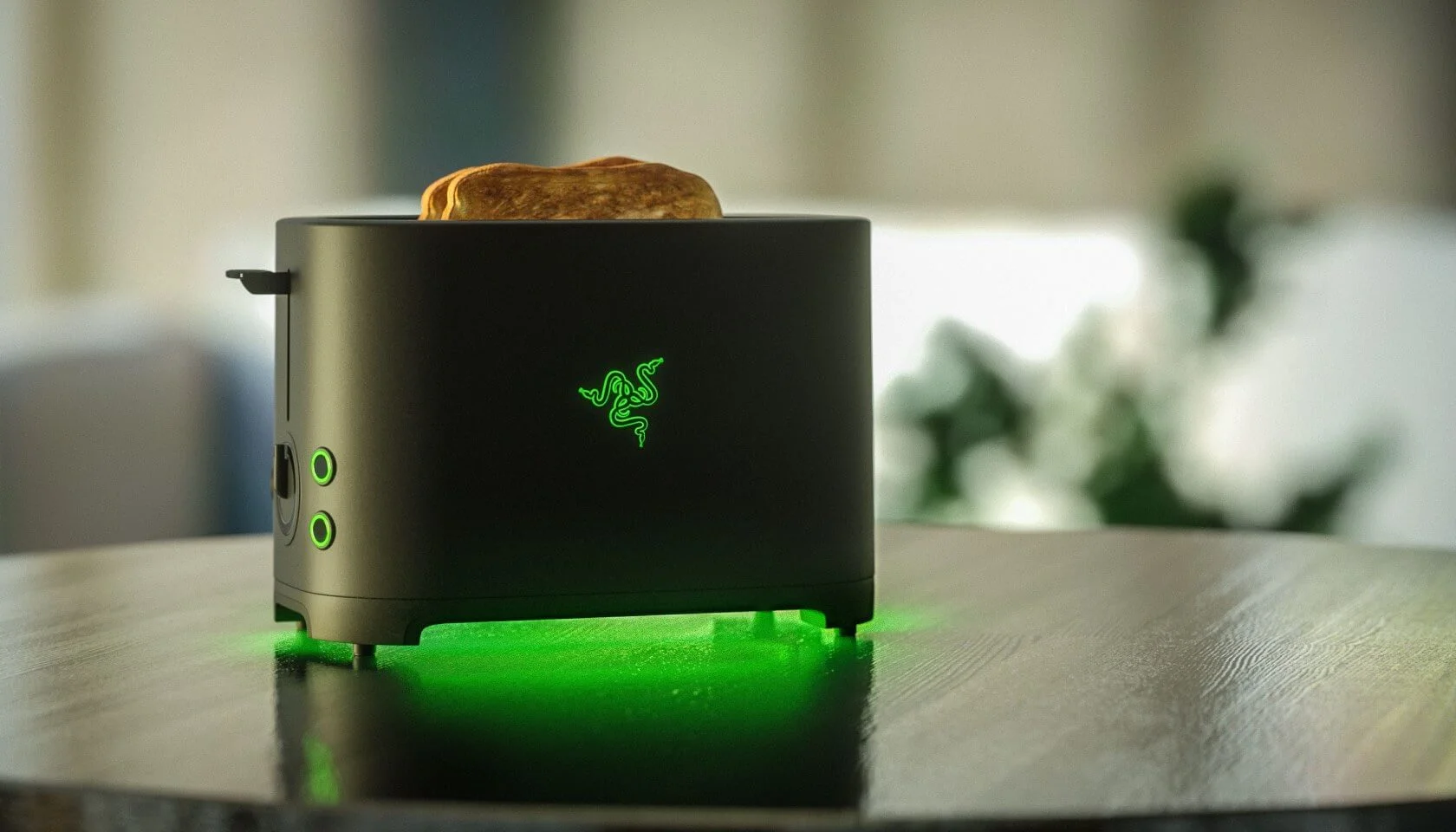 Razer Toaster — Black Razer-branded toaster with glowing green logo and toast popping out on a table.