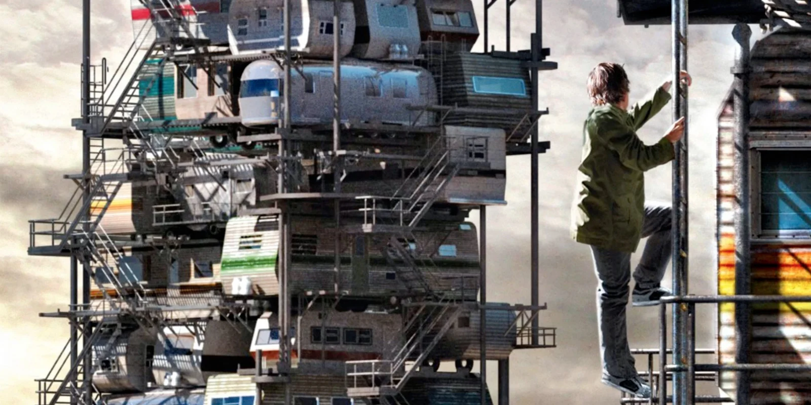 Ready Player One — A young man in a green jacket climbs scaffolding beside a massive tower of stacked trailer homes under a cloudy sky.
