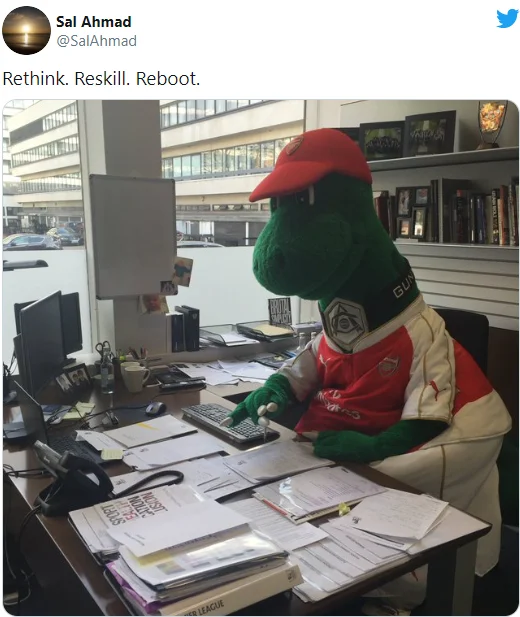 Rethink, Reskill, Reboot — Tweet showing Arsenal mascot Gunnersaurus at an office desk captioned with the 'Rethink. Reskill. Reboot.' slogan.