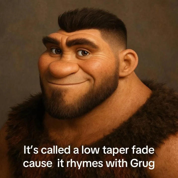 An expressive close-up of Grug's distinctive animated face paired with meme text humorously claiming a haircut style 'rhymes with Grug'.