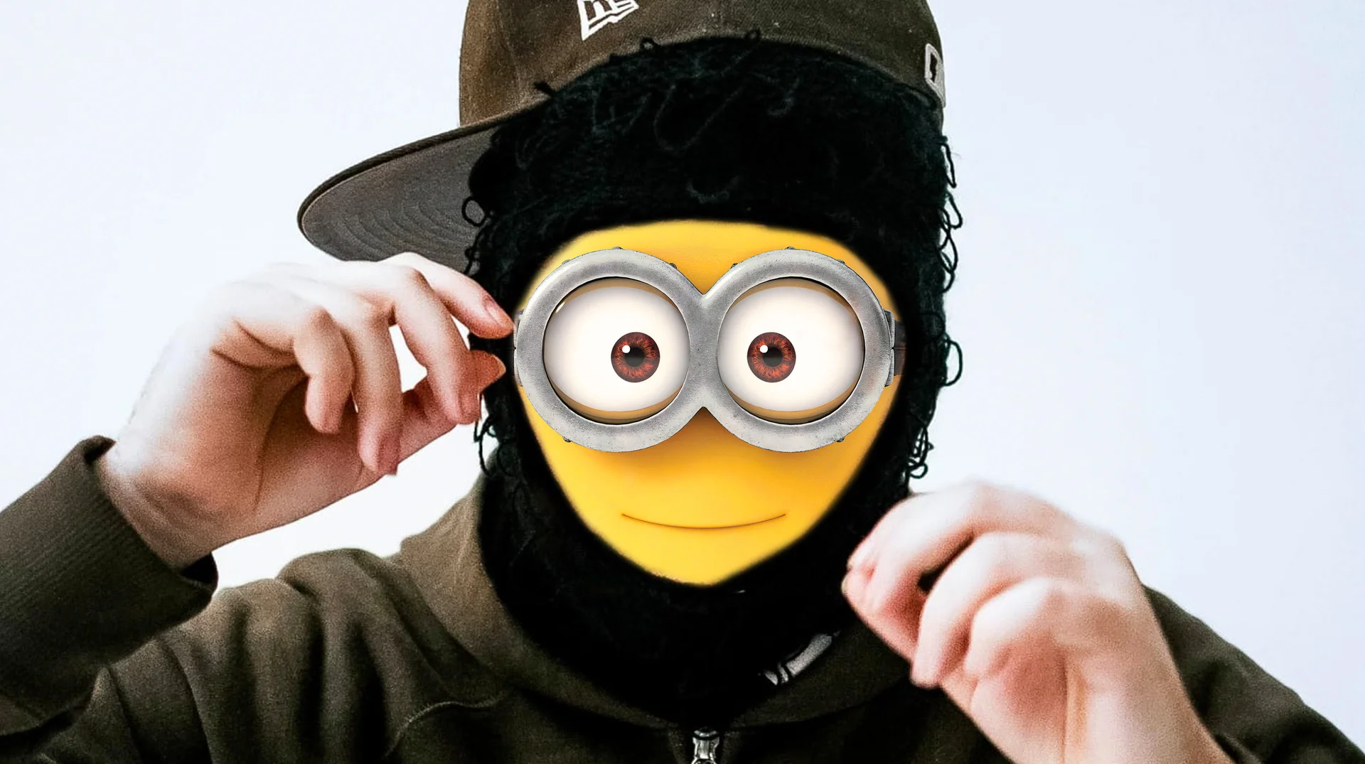 "Rich Minion" by Yeat — Rapper Yeat with Minion goggles and yellow face edited over his features, wearing a cap and ski mask