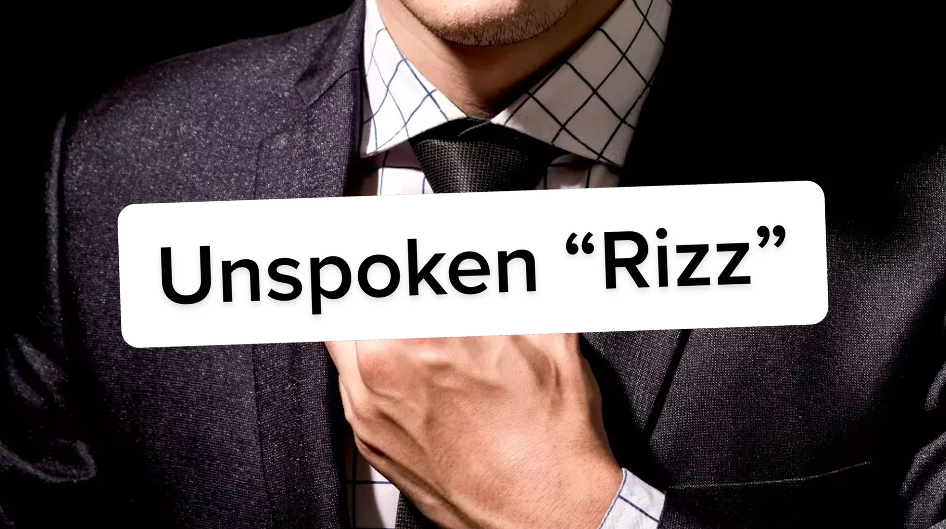 Rizz Unspoken Rizz — Man in suit and tie adjusting collar with the caption Unspoken Rizz