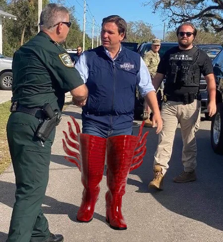 Ron DeSantis' White Boots — Edited image of Ron DeSantis wearing tall red flame-styled high-heeled boots instead of white rain boots.