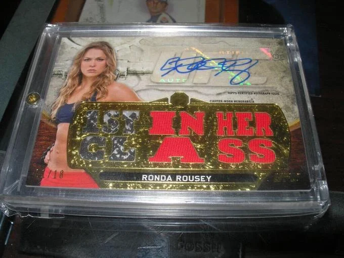 Autographed Ronda Rousey Topps trading card with 1st in her class pun