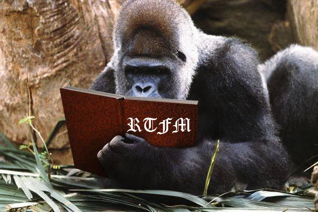 Gorilla holding a red book labeled RTFM.