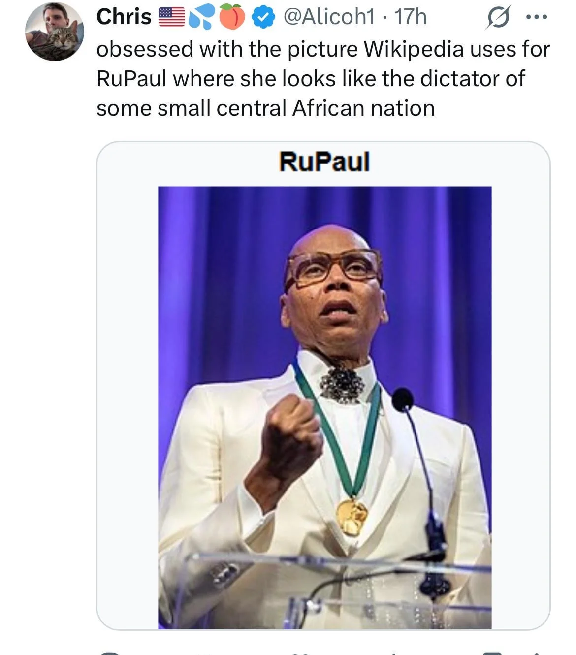 RuPaul's Drag Race — Tweet joking about RuPaul's Wikipedia photo looking like a dictator, with RuPaul in a white suit at a podium.
