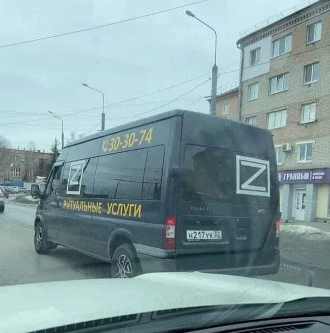 Russian Z Military Symbol — Russian funeral services van displaying a white Z symbol