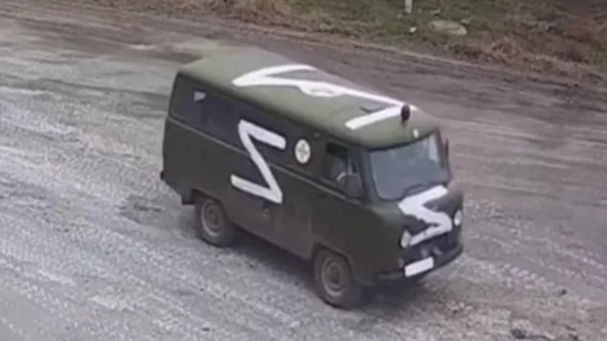 Russian Z Military Symbol — Russian military UAZ van marked with large white Z symbols on side and roof
