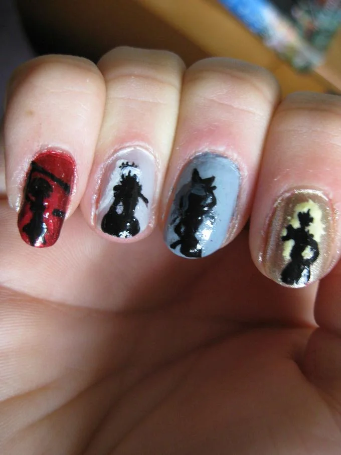 Fingernails with RWBY character silhouette nail art in team colors