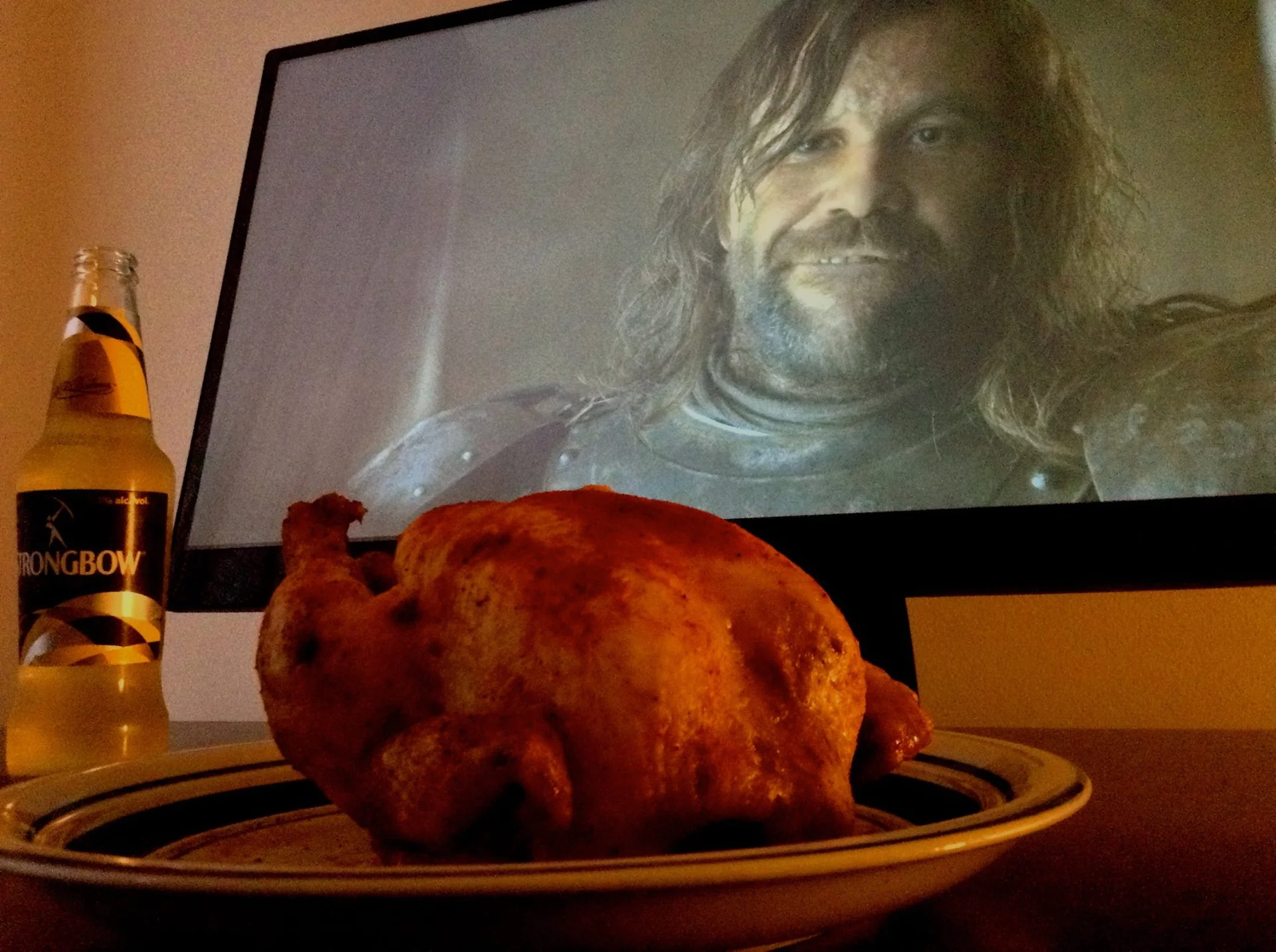 Sandor Clegane Loves Chicken — Roast chicken and Strongbow cider in front of a TV showing The Hound