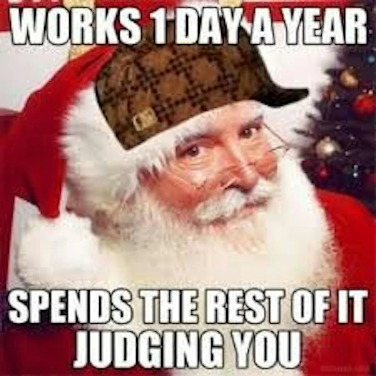 Close-up of Santa's face with characteristic judging expression showing white beard and red suit with impact font text 'WORKS 1 DAY A YEAR' and 'SPENDS THE