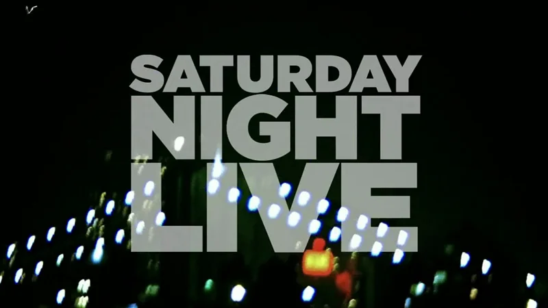 Saturday Night Live (SNL) — Saturday Night Live logo in white letters against a blurred nighttime city background