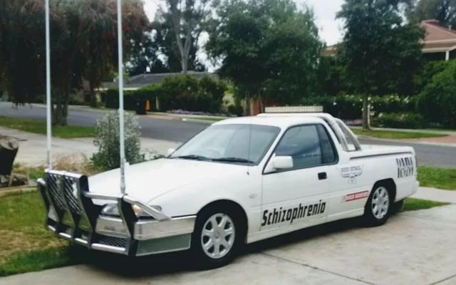 Schizophrenia Rides Schizo Whips — White Holden ute parked in driveway with the word Schizophrenia on the side