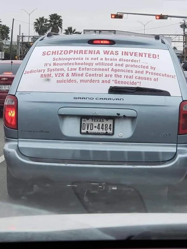 Schizophrenia Rides Schizo Whips — Dodge Grand Caravan with a rear-window sign claiming schizophrenia was invented by neurotechnology
