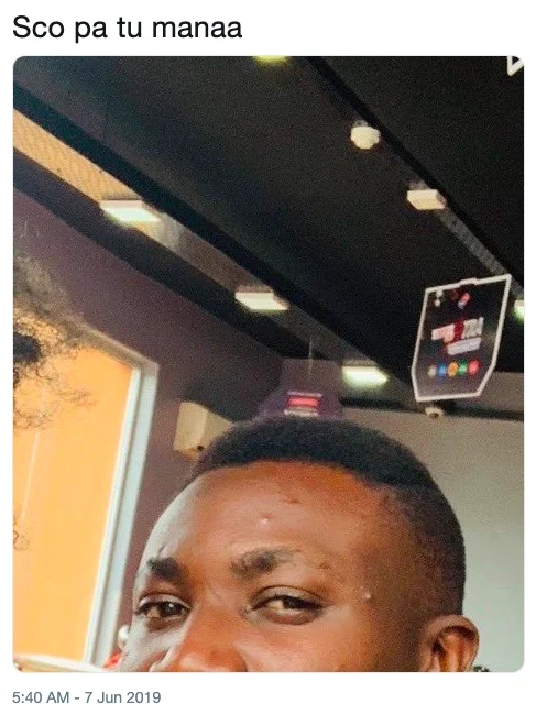 Tweet reading 'Sco pa tu manaa' with a tilted selfie of a smiling man indoors
