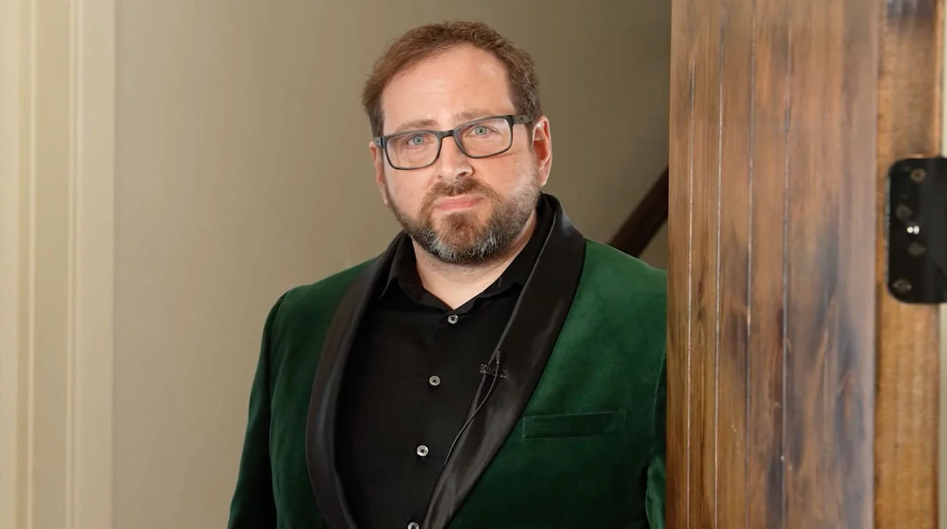 Scott Cawthon's MatPat Final Theory Cameo — Scott Cawthon in green velvet blazer leaning on a doorframe looking at the camera