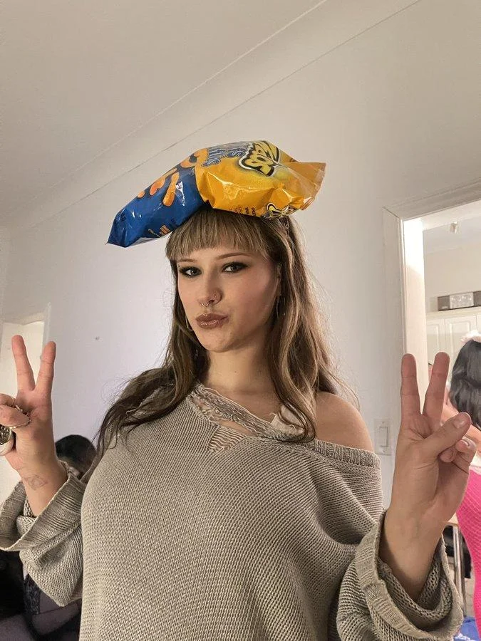 Shes So Crazzzzzzzy Love Her — Young woman recreating the meme with a cheese puff bag on her head and peace signs