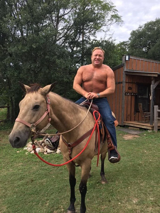 Shirtless Alex Jones at Lunch — Shirtless Alex Jones smiling while riding a tan horse outdoors