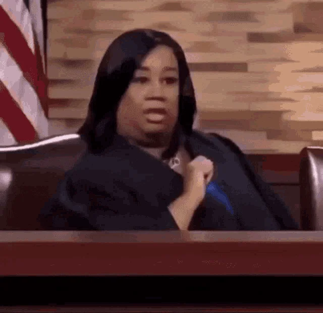 Shocked Judge Dana Cutler — Animated GIF of Judge Dana Cutler clutching her chest with a shocked expression at the bench.