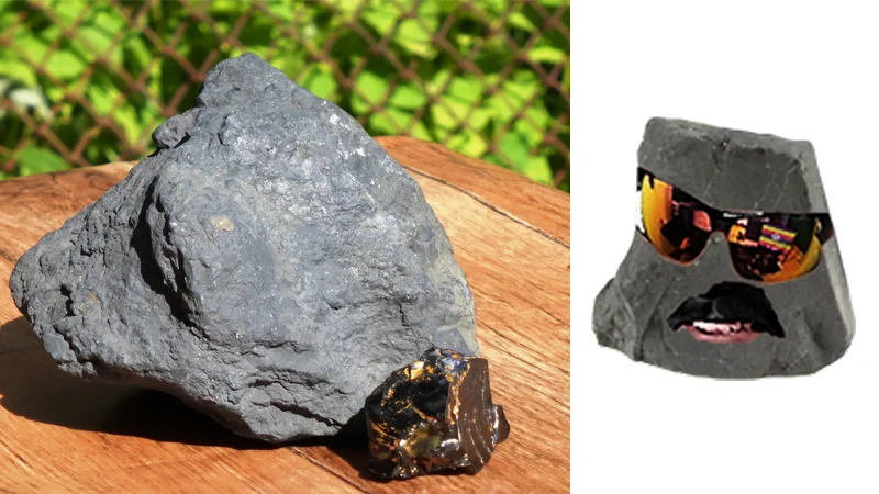 Shungite rocks next to a shungite stone decorated with sunglasses and a mustache face