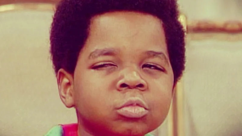 A young child gives a sharp, judgmental side eye glance with a visibly skeptical and unimpressed expression.