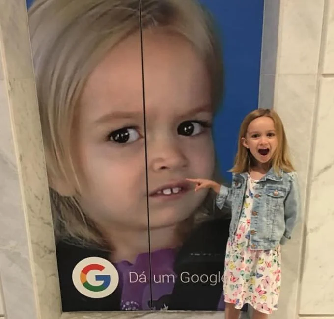 Side Eye — A young girl stands beside a large Google advertisement display featuring her portrait in a photo composite.