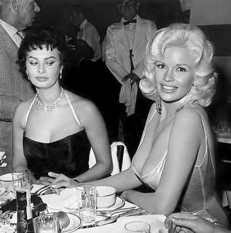 Side Eye — A woman in casual attire gives a sharp, judgmental glance with an unimpressed expression conveying disapproval.
