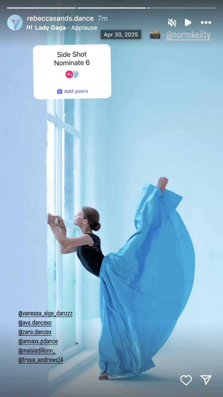 A dancer or gymnast in a blue leotard captured in an extended side profile artistic pose participating in the Side Shot Nominate 6 trend.