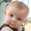 A clean, close-up image of the Skeptical Baby with a characteristic cocked eyebrow and suspicious expression without text overlay.