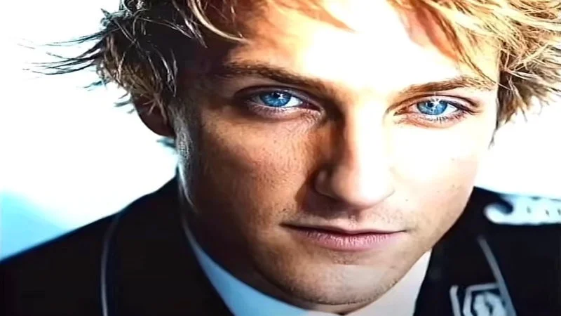 Skibidi Sigma — An AI-enhanced close-up photograph of a young man with striking blue eyes and stoic expression evoking the classic sigma male aesthetic.